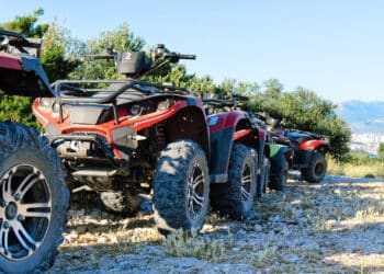 Parked atv and utv on a mountain road.