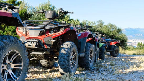 Parked atv and utv on a mountain road.