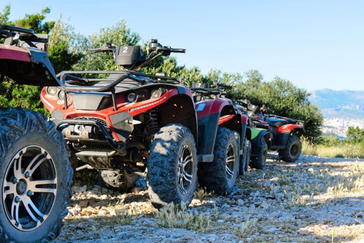 Parked atv and utv on a mountain road.