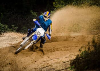 Bike rider in action turning on sand terrain.