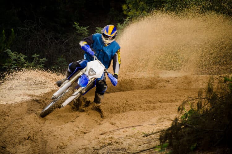Bike rider in action turning on sand terrain.