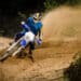 Bike rider in action turning on sand terrain.