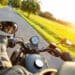 Motorcycle driver riding on motorway in beautiful sunset light. shot from pillion driver view