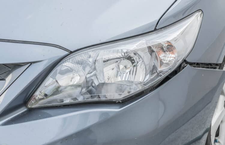 Close up of a silver car head light