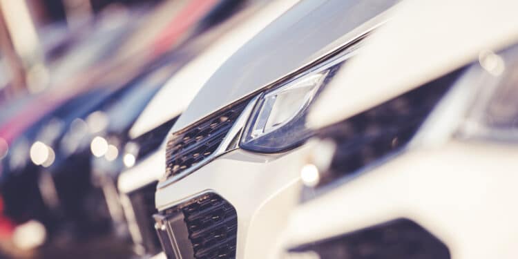 Close up of the front end of cars on a dealership lot