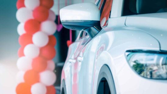 Side mirror white car parked in modern showroom