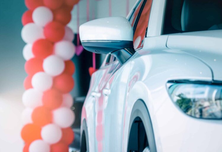 Side mirror white car parked in modern showroom