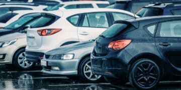 Row of used cars in the rain