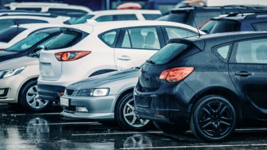 Row of used cars in the rain