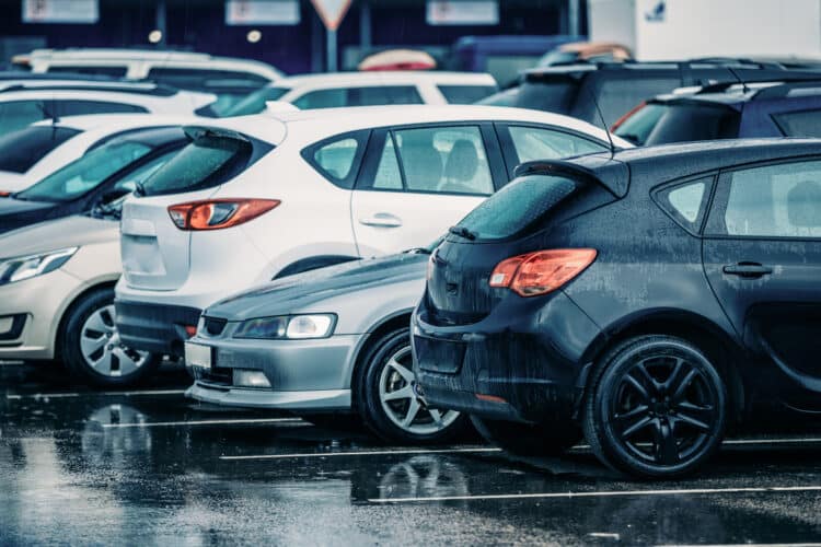 Row of used cars in the rain