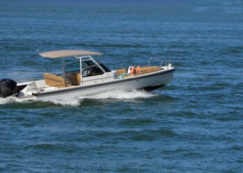 Two people taking a leisurely afternoon cruise in an open sports fishing boat