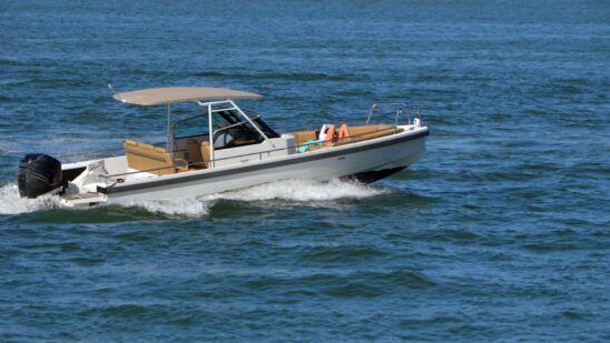 Two people taking a leisurely afternoon cruise in an open sports fishing boat