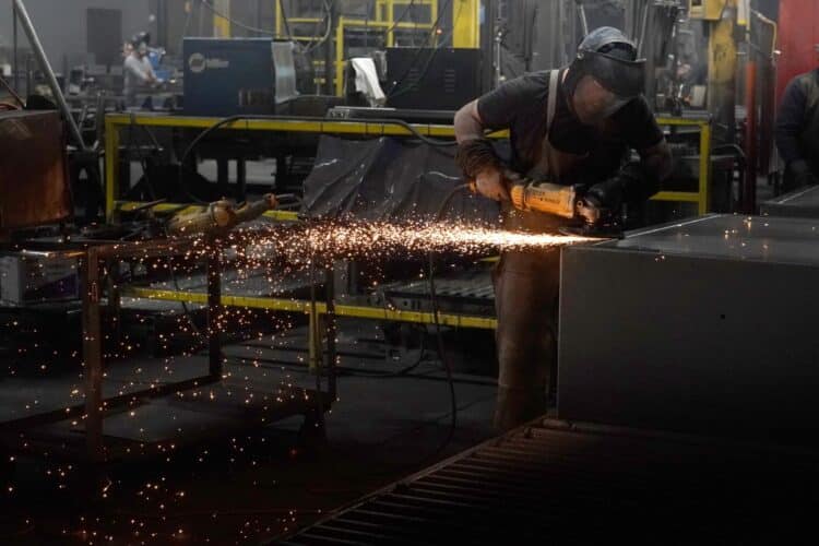 A worker welds a safe that is being manufactured in Payson, Utah.