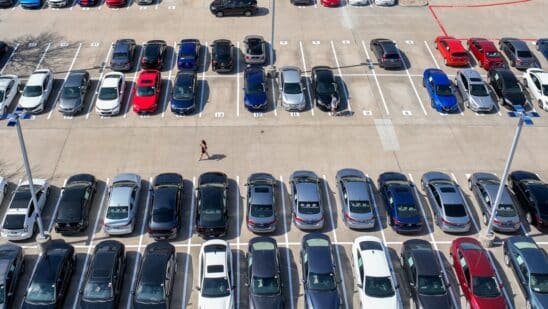 a customer walks through a Carmax dealership