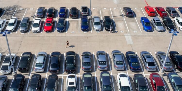 a customer walks through a Carmax dealership