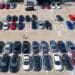 a customer walks through a Carmax dealership