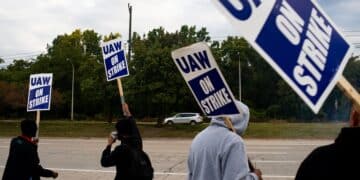 United Auto Workers (UAW) members and supporters on a picket line outside the Ford Motor Co. Michigan Assembly plant in Wayne, Michigan, US, on Wednesday, Sept. 20, 2023. The United Auto Workers said more of its members will go on strike at General Motors Co., Ford Motor Co. and Stellantis NV facilities starting at noon Friday unless substantial headway is made toward new labor contracts. Photographer: Emily Elconin/Bloomberg