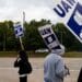 United Auto Workers (UAW) members and supporters on a picket line outside the Ford Motor Co. Michigan Assembly plant in Wayne, Michigan, US, on Wednesday, Sept. 20, 2023. The United Auto Workers said more of its members will go on strike at General Motors Co., Ford Motor Co. and Stellantis NV facilities starting at noon Friday unless substantial headway is made toward new labor contracts. Photographer: Emily Elconin/Bloomberg