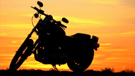 Motorcycle with a sunset behind it