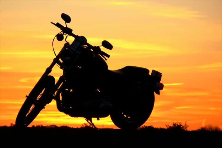 Motorcycle with a sunset behind it