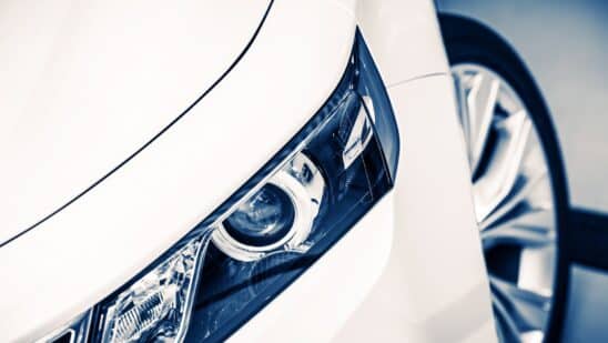 Close up of headlight on a white car