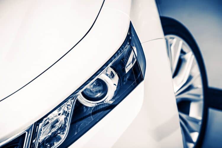 Close up of headlight on a white car