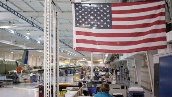 An American flag above employees at a factory in Wichita, Kansas.