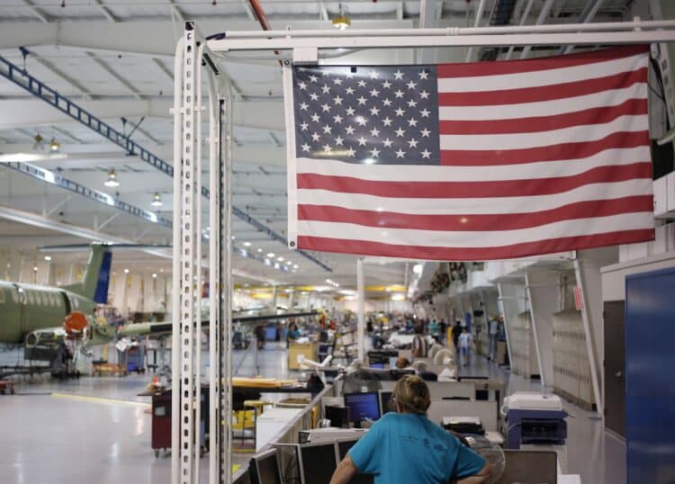 An American flag above employees at a factory in Wichita, Kansas.