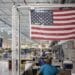 An American flag above employees at a factory in Wichita, Kansas.