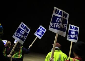 Factory workers and UAW union members form a picket line on Oct. 12.