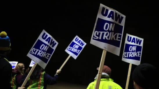 Factory workers and UAW union members form a picket line on Oct. 12.