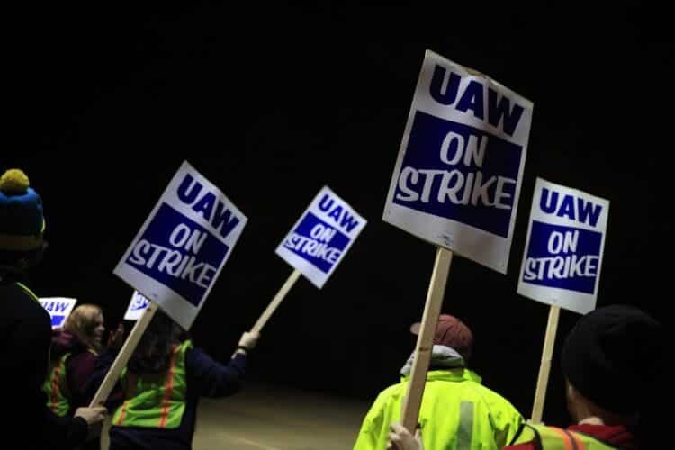 Factory workers and UAW union members form a picket line on Oct. 12.