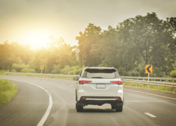 Car driving with the sunset in the back