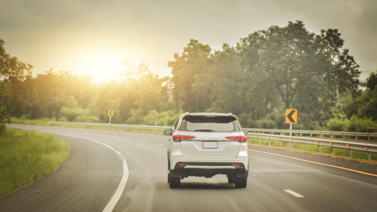 Car driving with the sunset in the back