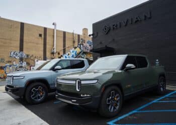 Rivian R1T electric pickup trucks parked at a Rivian service center in the Brooklyn