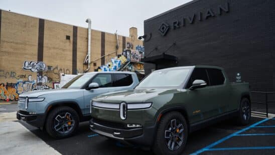 Rivian R1T electric pickup trucks parked at a Rivian service center in the Brooklyn