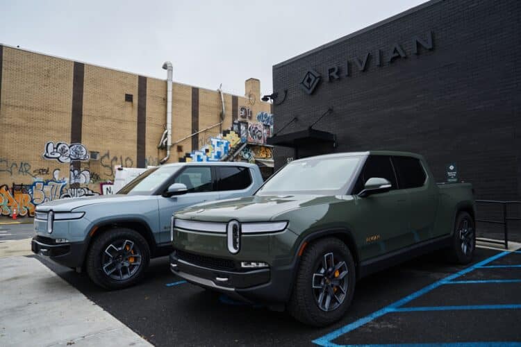 Rivian R1T electric pickup trucks parked at a Rivian service center in the Brooklyn