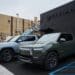 Rivian R1T electric pickup trucks parked at a Rivian service center in the Brooklyn