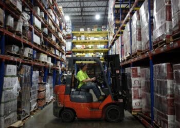 A worker uses a forklift to move a pallet at a distribution warehouse in Louisville, Kentucky.