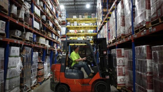 A worker uses a forklift to move a pallet at a distribution warehouse in Louisville, Kentucky.
