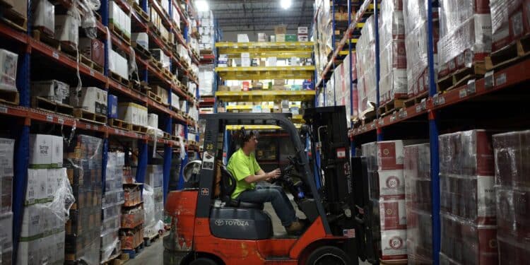 A worker uses a forklift to move a pallet at a distribution warehouse in Louisville, Kentucky.