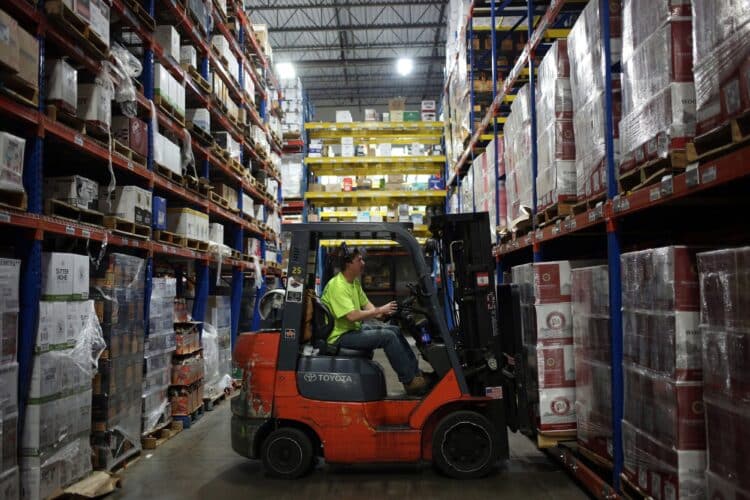 A worker uses a forklift to move a pallet at a distribution warehouse in Louisville, Kentucky.