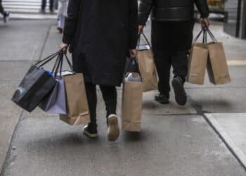 Shoppers carry bags in New York.