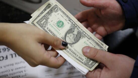 An employee returns change to a customer at a Best Buy Co. store in Louisville.