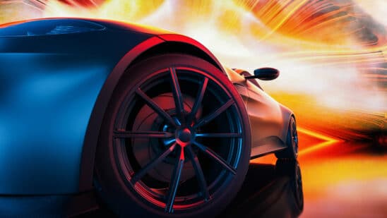 Close up of a car front tire with a red and yellow lights behind it
