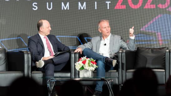 Tom Shortt on stage with JJ Hornblass at Auto Finance Summit 2023