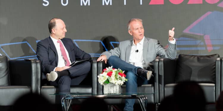 Tom Shortt on stage with JJ Hornblass at Auto Finance Summit 2023