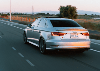 Car driving lit up by the sunset