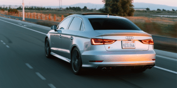 Car driving lit up by the sunset