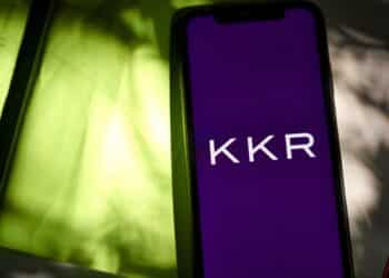 The KKR & Co. logo on a smartphone arranged in the Brooklyn borough of New York